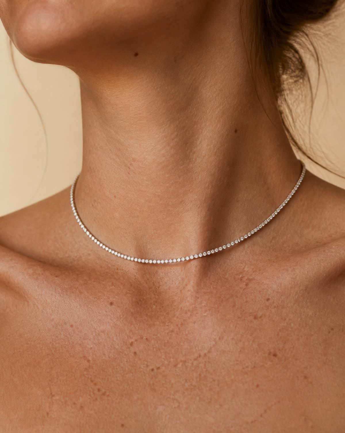 RW The Line 2mm diamond tennis necklace worn at the base of the throat, 16 inches